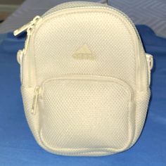 Adidas Women's Mini Backpack. Alumina Beige. Adidas White Bag For Everyday Use, White Adidas Bag For Everyday Use, Everyday Backpack With Mesh Pockets, Everyday Adidas Nylon Bag, White Adidas Sporty Backpack, Daily Use Mesh Backpack Bag, Adidas Nylon Bag With Adjustable Strap, White Mesh Travel Bag, Sporty Adidas Backpack With Zipper Closure