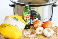 the ingredients for this meal are in front of an electric pressure cooker, including onions and garlic