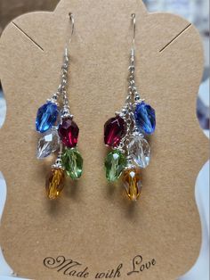 "These earrings are handmade using Swarovski crystals in shades of red, green, blue, gold and clear ab (aurora borealis).  The silver chain, spacers and ear wires are all .925 sterling silver (not plated or mystery metal)  They are approximately 2 1/4 inches long.   Little clear rubber \"stoppers\" that can be placed on the back of the earring to prevent loss will be included.  The earrings will come packaged in a pretty little organza pouch, perfect for gift giving or storage." Holiday Beaded Jewelry, Wine Charms Diy, Diy Christmas Earrings, Christmas Jewelry Diy, Swarovski Christmas, Diy Earrings Easy, Earring Kit, Beaded Earrings Tutorials, Organza Pouch