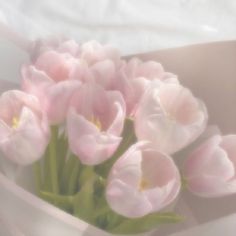 a bunch of pink flowers in a white vase