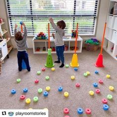 two young boys playing with toys in a playroom