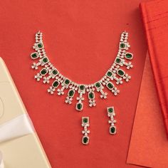 Description: Jvalant Delicate CZ Necklace set is made for women who want to stand out from the crowd. This bold and ravishing design is crafted with the finest CZ stones and most brilliant gold plating. Jvalant will be delightful to pair with your elegant gowns and wear on your special events. Details & Specifications: Materials used: CZ stones with Rhodium Plating Weight - Necklace: 41 gms, Earrings: 7 gms Length - Necklace: 11.5 cms, Earrings: 3.5 cms Make it customWant to make it a custom nec Elegant Festive Bridal Sets, Elegant Festive Crystal Jewelry Sets, Festive Elegant Crystal Jewelry Sets, Elegant Festive Jewelry Sets With Sparkling Stones, Elegant Festive Bridal Necklace With Cubic Zirconia, Elegant Bridal Cubic Zirconia Necklace For Festive Occasion, Glamorous Hand Set Jewelry For Celebrations, Hand-set Cubic Zirconia Party Sets, Elegant Cubic Zirconia Party Sets