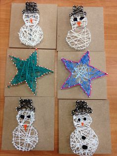 four snowmen made out of string on brown paper with blue and green stars in the middle