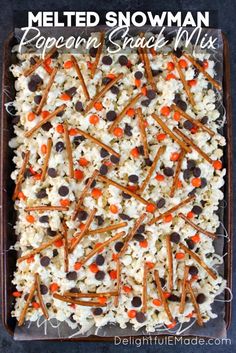 a tray filled with rice and carrots on top of a table