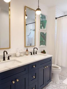 a white and blue bathroom with two sinks