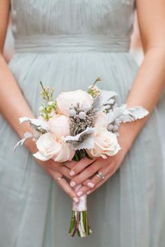 a bridesmaid holds her bouquet in her hands