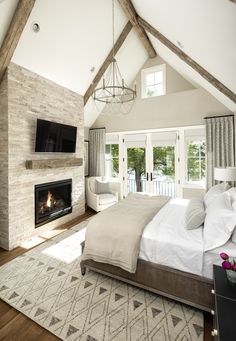 a bedroom with a fireplace and television in it