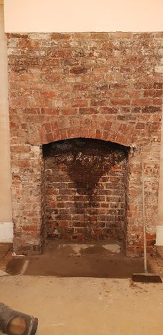 an old brick fireplace is being renovated