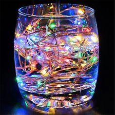 a glass filled with lots of colorful lights