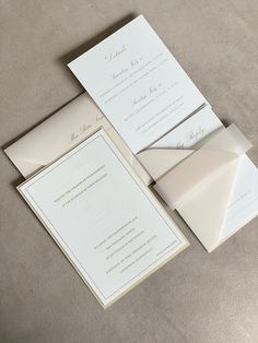 the wedding stationery is laid out on top of each other