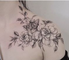 a woman with a cat and flowers tattoo on her chest