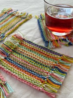 there is a glass of tea next to some crocheted placemats