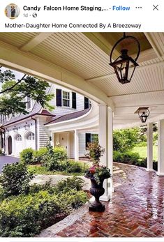 an image of a front porch with flowers in the vase and lights on the side