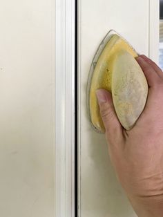 a person is cleaning the door with a sponge