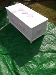 a white box sitting on top of a green tarp