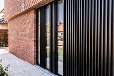 a brick building with black slats on it