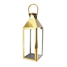 a gold colored lantern with a handle on the top and bottom, sitting against a white background