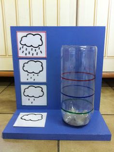 a glass with water in it sitting on top of a blue table next to a card