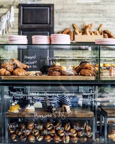 a bakery display case filled with lots of pastries