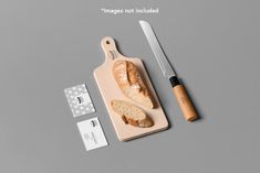 a cutting board with bread on it next to a knife and some tags that say images not included