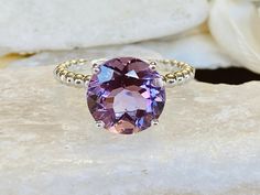 This beautiful solitaire setting contains a natural 3.8ct round Rose De France amethyst. The stone measures approximately 10mm. The band is 2mm wide and features beautiful beaded detailing. The ring is available in sterling silver, and 14k white, yellow, or rose gold. This ring makes a unique promise or engagement ring. Please send me a message if you need a size not listed. * This ring can be customized with any color center stone. All items are handmade by me in my shop in Woodbridge, NJ. Plea Luxury Round Crystal Ring With Amethyst, Round Amethyst Ring, Round Amethyst Ring With Center Stone, Amethyst Gemstone With Center Stone, Amethyst Ring With Round Stone, Amethyst Ring With Gemstone Accents, Purple Amethyst Solitaire Ring, Topaz Ring With Amethyst And Accent Stones, White Gold Amethyst Ring With Gemstone Accents