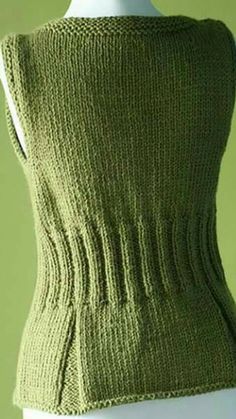 a green knitted vest on a mannequin's torso, with the back turned