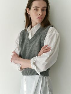 Short, soft, knit sweater vest in 100% superfine Merino wool. V-neck and ribbing at neckline, armholes, and hem.- Short- V-neck- Sleeveless Knitted V Neck Sweater Vest, Classic Sweater Vest For Winter Layering, Wool V-neck Workwear Tops, Wool V-neck Vest For Layering, Classic Sweater Vest For Work In Winter, V-neck Wool Tops For Workwear, Winter V-neck Vest For Everyday, Classic V-neck Sweater Vest, Winter Everyday V-neck Vest