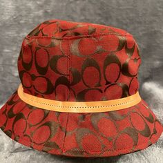 New W/ Tag Coach Burgundy Hat With Brown Leather Trim. Red Short Brim Cloche Hat For Fall, Designer Brown Hat For Spring, Trendy Brown Bucket Hat With Flat Brim, Trendy Brown Flat Brim Bucket Hat, Designer Brown Hats For Spring, Designer Brown Hat With Short Brim, Trendy Brown Bucket Hat With Curved Brim, Vintage Red Hat For Fall, Chic Red Hat For Fall