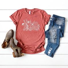 Looking for a cute versatile top to wear? Make sure to grab one of our Graphic tees! This soft and comfortable graphic tee is the perfect top for any outfit. It can be paiGrass with biker shorts, jeans, or even a simple skirt/dress! This tee is true-to-size, so be sure to order your regular t-shirt size! If you are looking for a more oversized look, make sure to size up! Spring Soft-washed Relaxed Fit T-shirt, Spring Graphic Tee Soft-washed, Spring Soft-washed Graphic Tee, Spring Cotton Graphic Tee Tops, Spring Graphic Tee Cotton Tops, Spring Graphic Cotton Tee, Casual Soft-washed Tops For Spring, Spring Soft-washed Comfortable Fit Tops, Spring Soft-washed Comfortable Tops