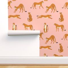 a pink wall with giraffes and other animals on it