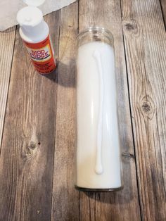 a bottle of milk next to a tube of toothpaste on a wooden table