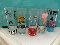 a group of glasses sitting on top of a white counter next to eachother