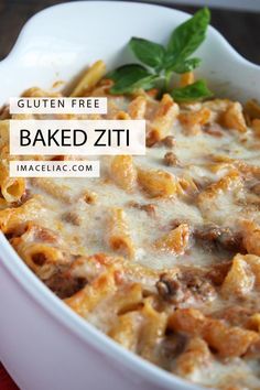 baked ziti with meat and cheese in a white casserole dish on a red cloth