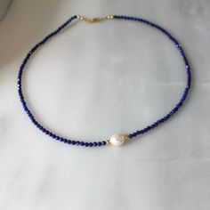 Natural Lapis Necklace for Women, Birthday Gifts for HerStunning and chic this beaded lapis lazuli necklace is the perfect everyday necklace or gift. Lapis is know as the friendship stone!•Gorgeous, genuine and natural 3mm lapis lazuli beaded by hand with freshwater pearl•Adorned with 14kt gold filled accents Water friendly Lapis Lazuli Beaded Necklace With Faceted Beads For Gift, Blue Lapis Lazuli Pearl Necklace Gift, Adjustable Single Strand Lapis Lazuli Beaded Necklace, Adjustable Single Strand Lapis Lazuli Necklace, Adjustable Sapphire Beaded Necklace Gift, Sapphire Beaded Necklace As Gift, Adjustable Lapis Lazuli Necklace With Faceted Beads, Lapis Lazuli Beaded Necklaces For Gift, Single Strand Lapis Lazuli Beaded Necklace As Gift