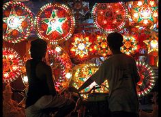 two people are standing in front of lighted decorations