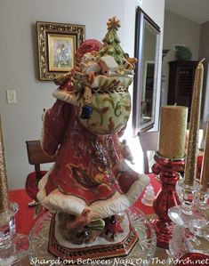 a table topped with a vase filled with flowers and other things on top of it