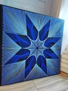 a blue and black painting on the floor