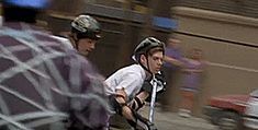 two men riding on the backs of bicycles