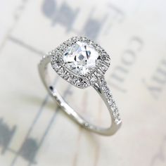 This beautiful Sterling Silver Rhodium Plated 1.25ct Square CZ Halo Solitaire Engagement Ring by Double Accent is meticulously crafted in gleaming and durable Sterling Silver. Our stones are the highest quality diamond simulants that are polished, finely cut, loupe clean, and have an exactly similar appearance and as beautiful as to naturally occurring diamonds. All cubic zirconia stone weights are approximate and listed as diamond equivalent weight in carats. Our client's satisfaction means the Halo Solitaire Engagement Ring, Vintage Halo Ring, Vintage Anniversary Rings, Vintage Anniversary, Vintage Halo, Silver Ring For Women, Sterling Silver Wedding Band, Sterling Silver Wedding Rings, Gold And Silver Rings