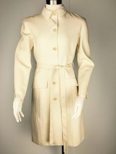 Chic Belted Beige Wool Coat, Elegant Beige Outerwear With Self Belt, Classic Beige Wool Coat With Belted Cuffs, Beige Wool Coat With Belted Cuffs For Work, Beige Long Wool Coat With Belted Cuffs, Cream Double-breasted Wool Coat For Work, Belted Beige Wool Coat, Elegant Cream Outerwear With Belted Cuffs, Beige Belted Long Wool Coat