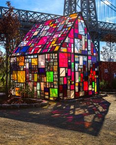 a house made out of stained glass with a bridge in the background