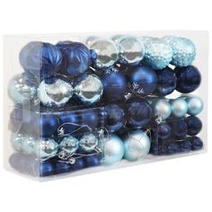 a stack of blue and silver ornaments in a clear display case on a white background