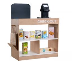 the check - out counter is made from wood and has various types of items on it