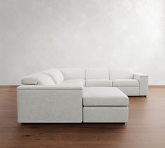 a white couch sitting on top of a wooden floor