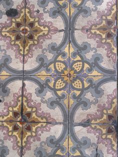 an old tile floor with colorful designs on it's sides and the top half