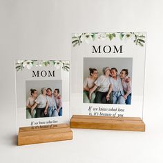 two wooden frames with the words, mom and dad on them are sitting next to each other