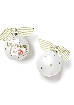 two white christmas ornaments with bows on them