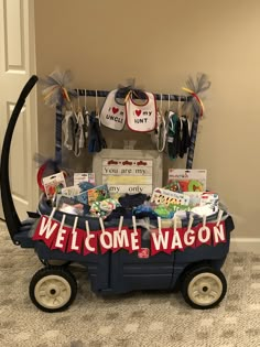 a wagon filled with baby items sitting on top of a carpeted floor next to a door