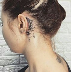 a woman with a flower tattoo behind her ear