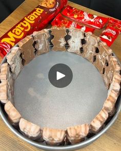 a metal bowl filled with chocolate and candy